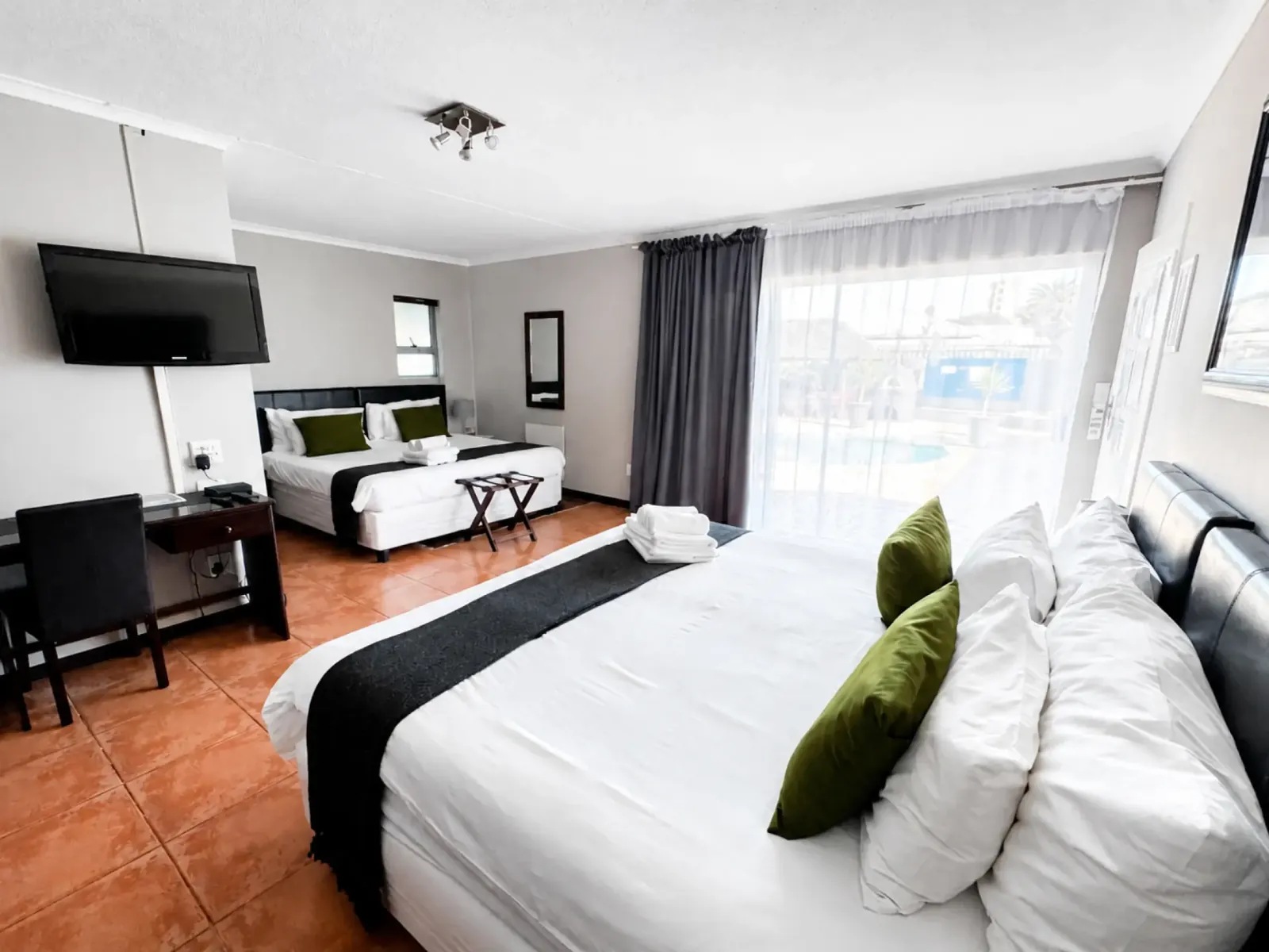 Spacious guest room opening toward the pool at Ilanga Du Cap Hotel