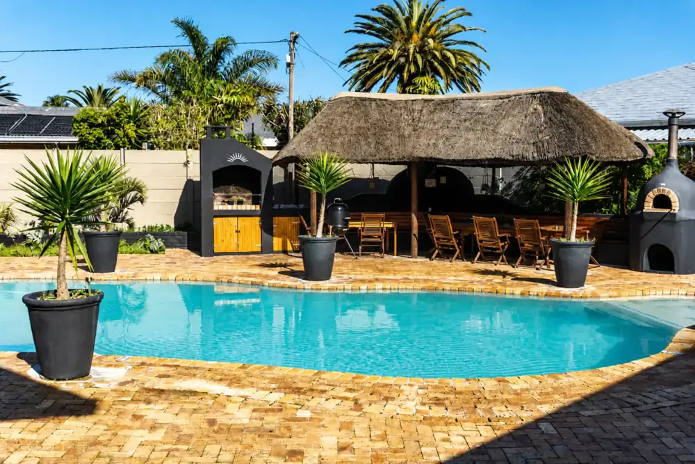 Hotel pool and thatched outdoor dining area